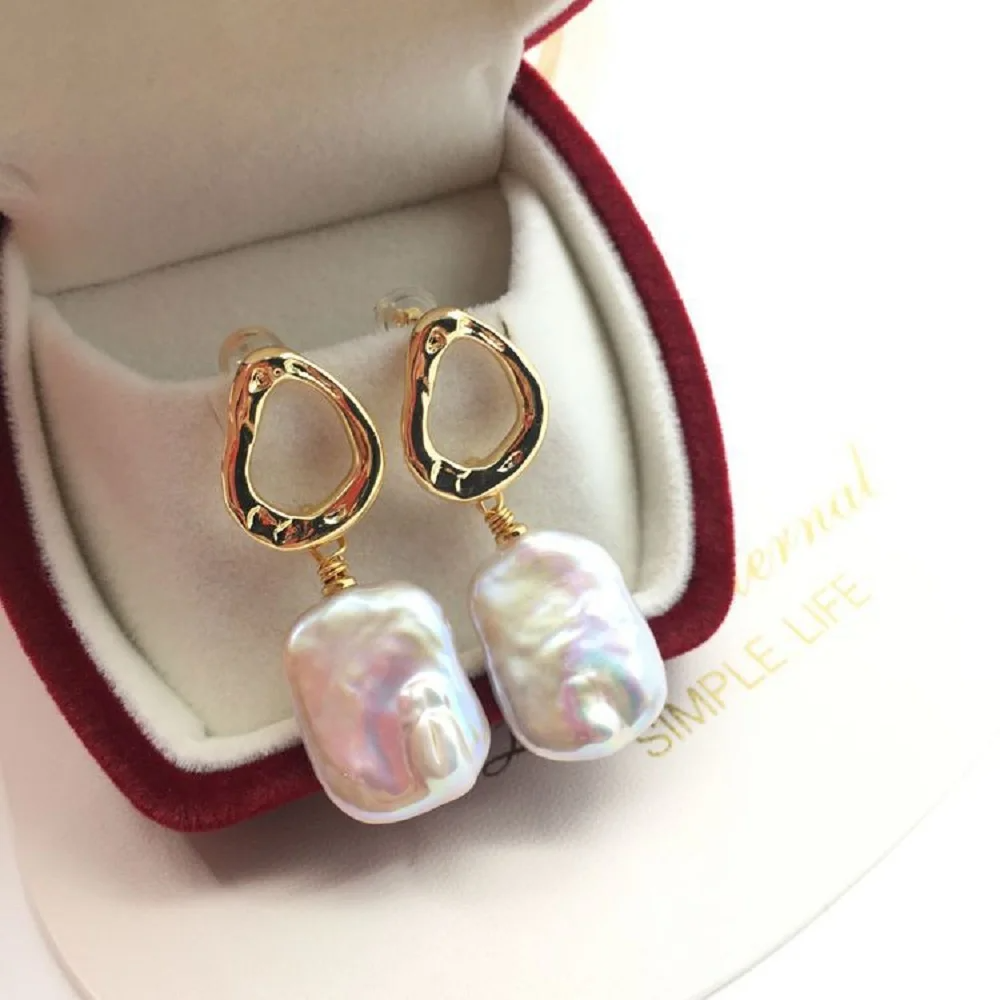 Baroque freshwater pearl drop earrings with gold abstract stud design in a velvet gift box.