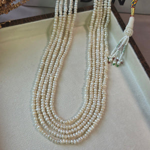 Handcrafted multi-strand freshwater pearl mala necklace with adjustable dori displayed in a jewelry box