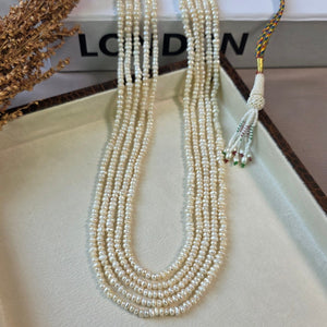 Handcrafted multi-strand freshwater pearl mala necklace with adjustable dori displayed in a jewelry box