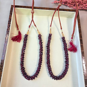 Handcrafted natural garnet stone mala necklace with deep red polished beads and adjustable thread closure.