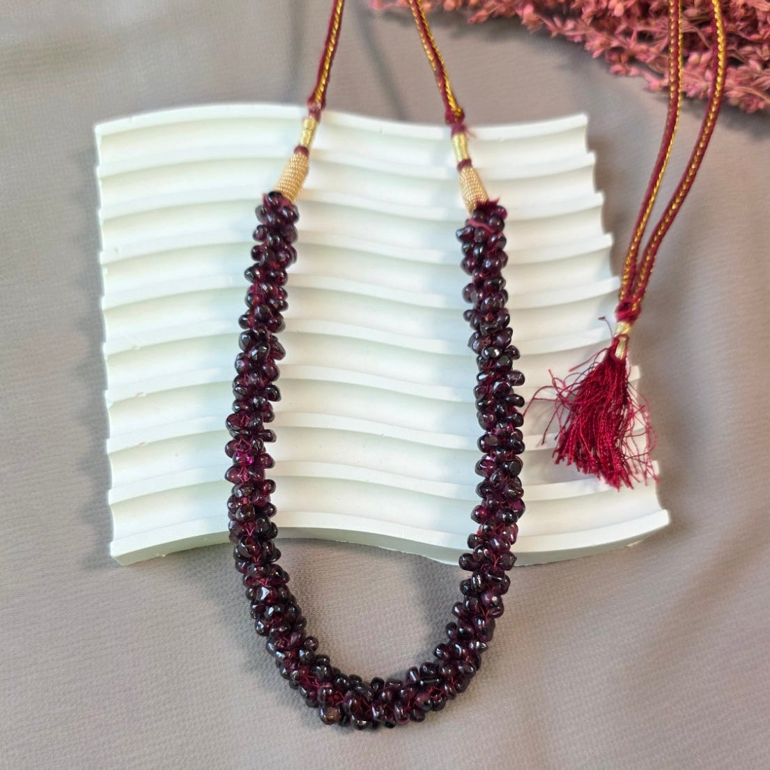 Handcrafted natural garnet stone mala necklace with deep red polished beads and adjustable thread closure.