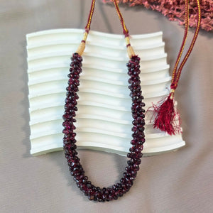Handcrafted natural garnet stone mala necklace with deep red polished beads and adjustable thread closure.