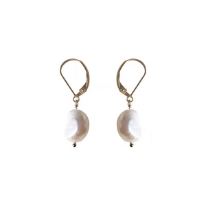 Elegant freshwater pearl drop earrings with gold lever-back hooks on white fabric background.