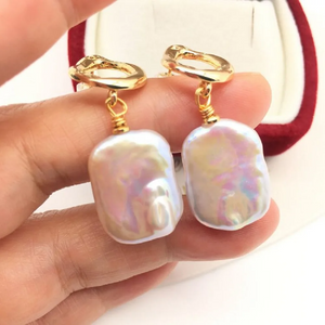 Baroque freshwater pearl drop earrings with gold abstract stud design in a velvet gift box.