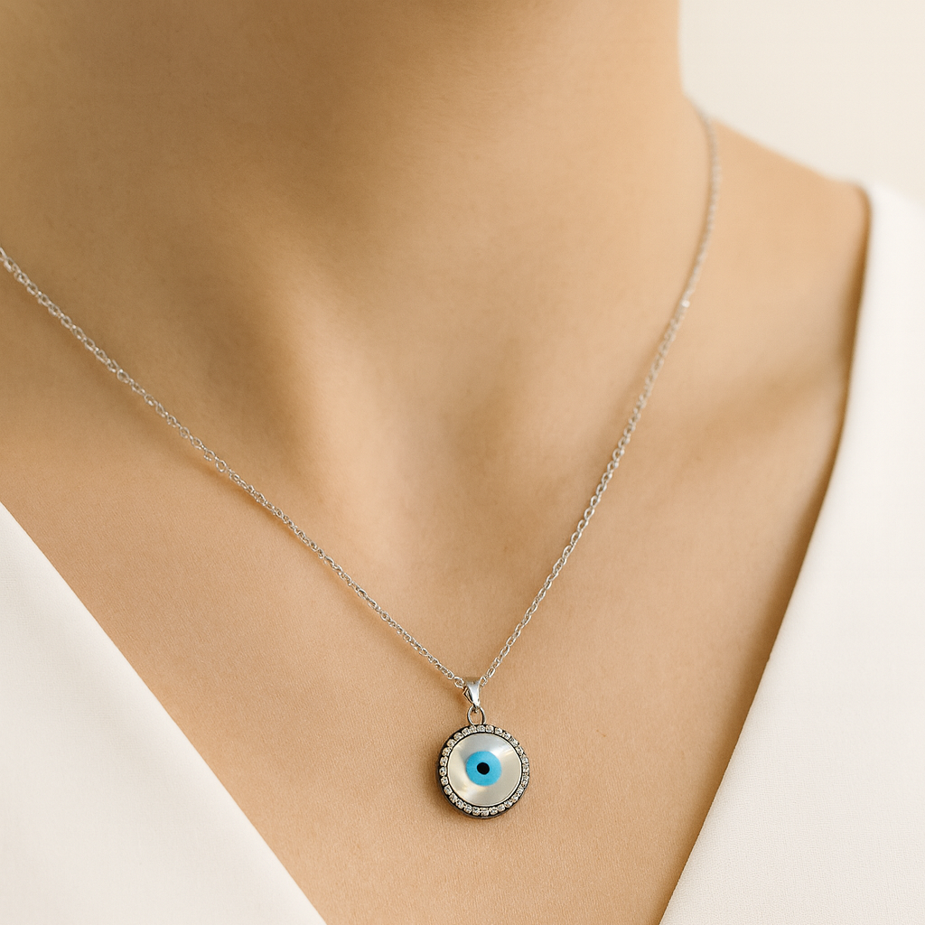 Necklace with a round pendant featuring an eye design on a mannequin.