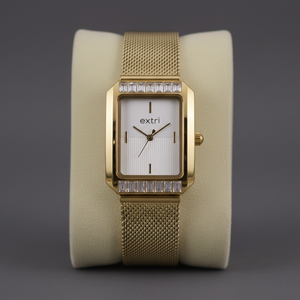 Gold wristwatch with a white face on a gray background