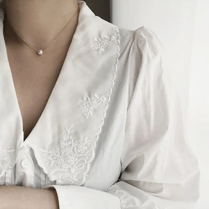 Elegant freshwater pearl pendant necklace with 18K gold-plated chain by Urban Gear displayed on neutral background