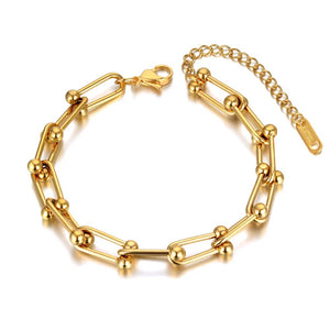 Gold chain bracelet on a white background
