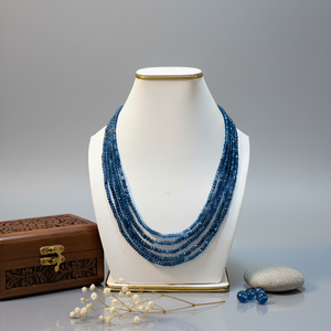 Blue jade multi-layer mala necklace displayed on jewelry stand.