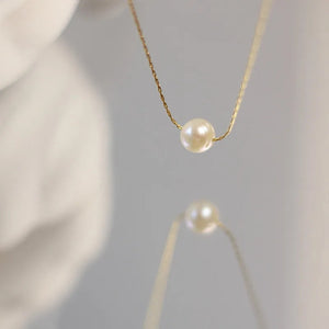 Elegant freshwater pearl pendant necklace with 18K gold-plated chain by Urban Gear displayed on neutral background