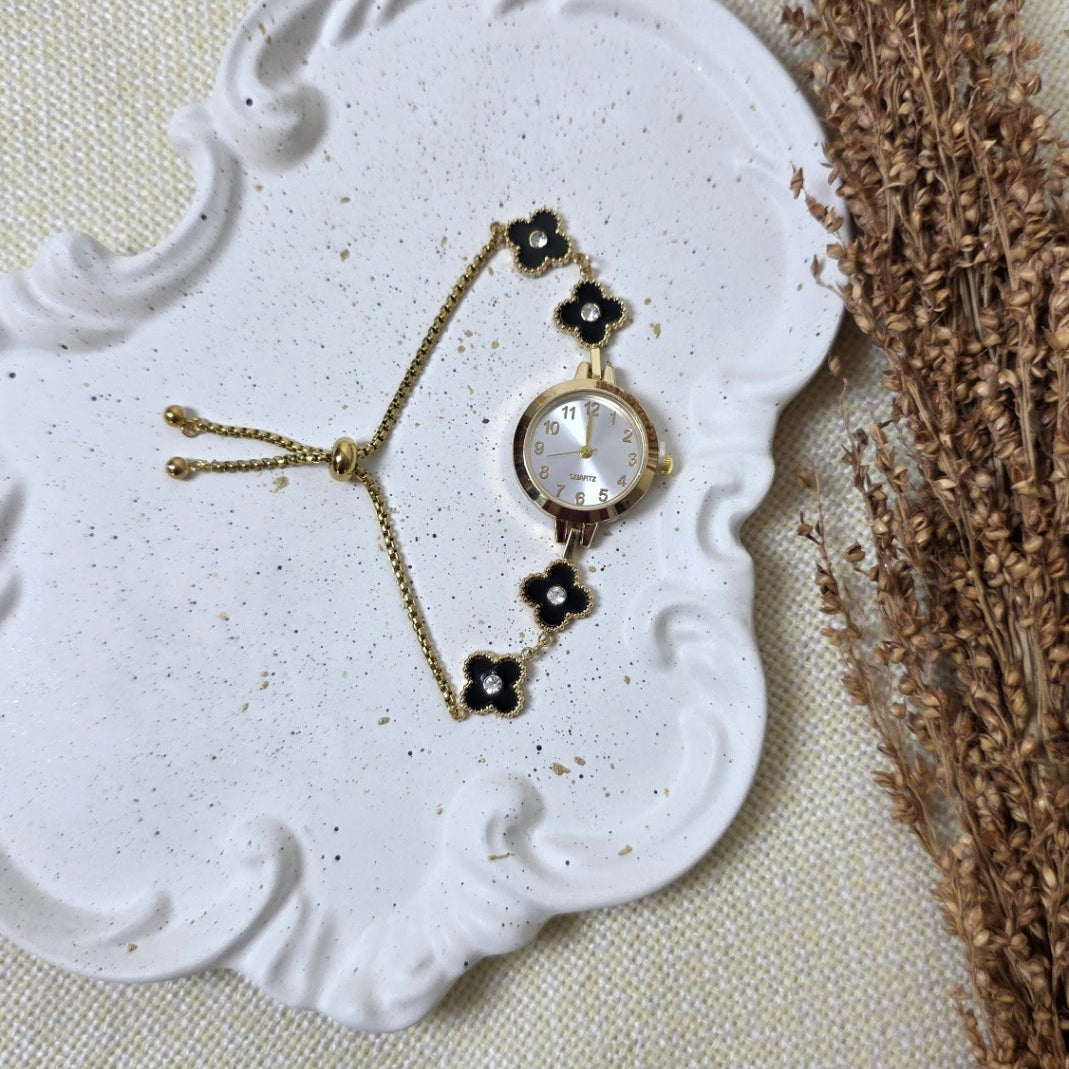 Bracelet with black beads on a decorative white stone surface
