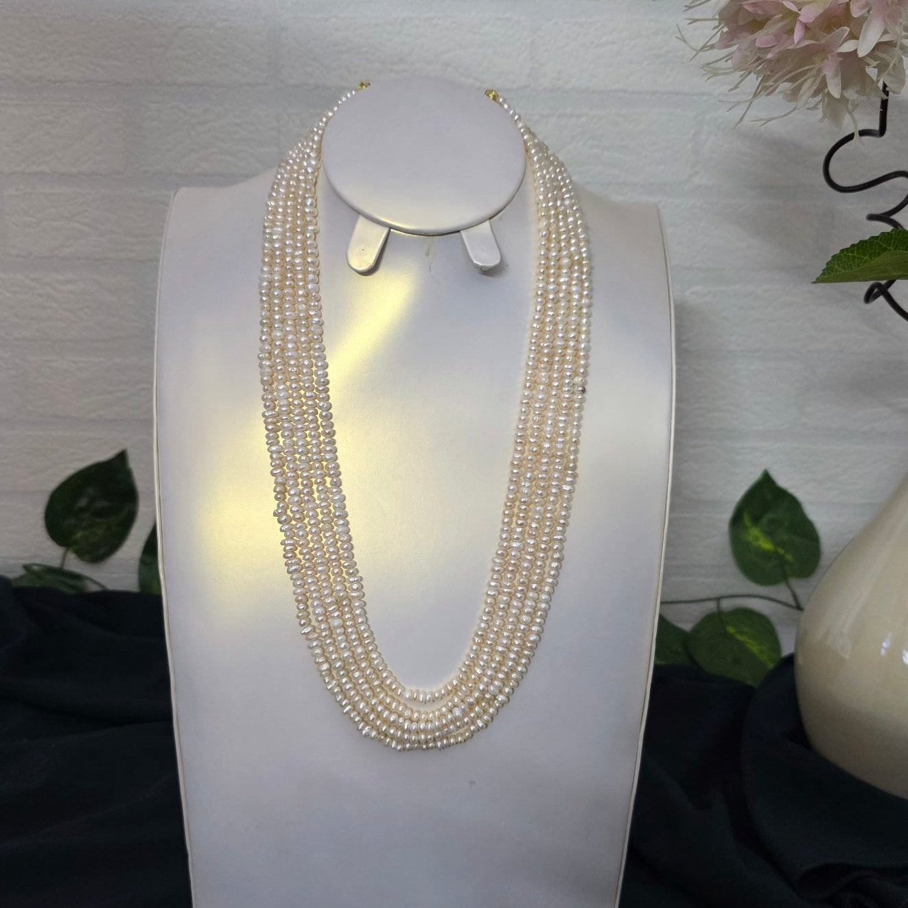 Decorative wall light fixture with crystal accents on a white background