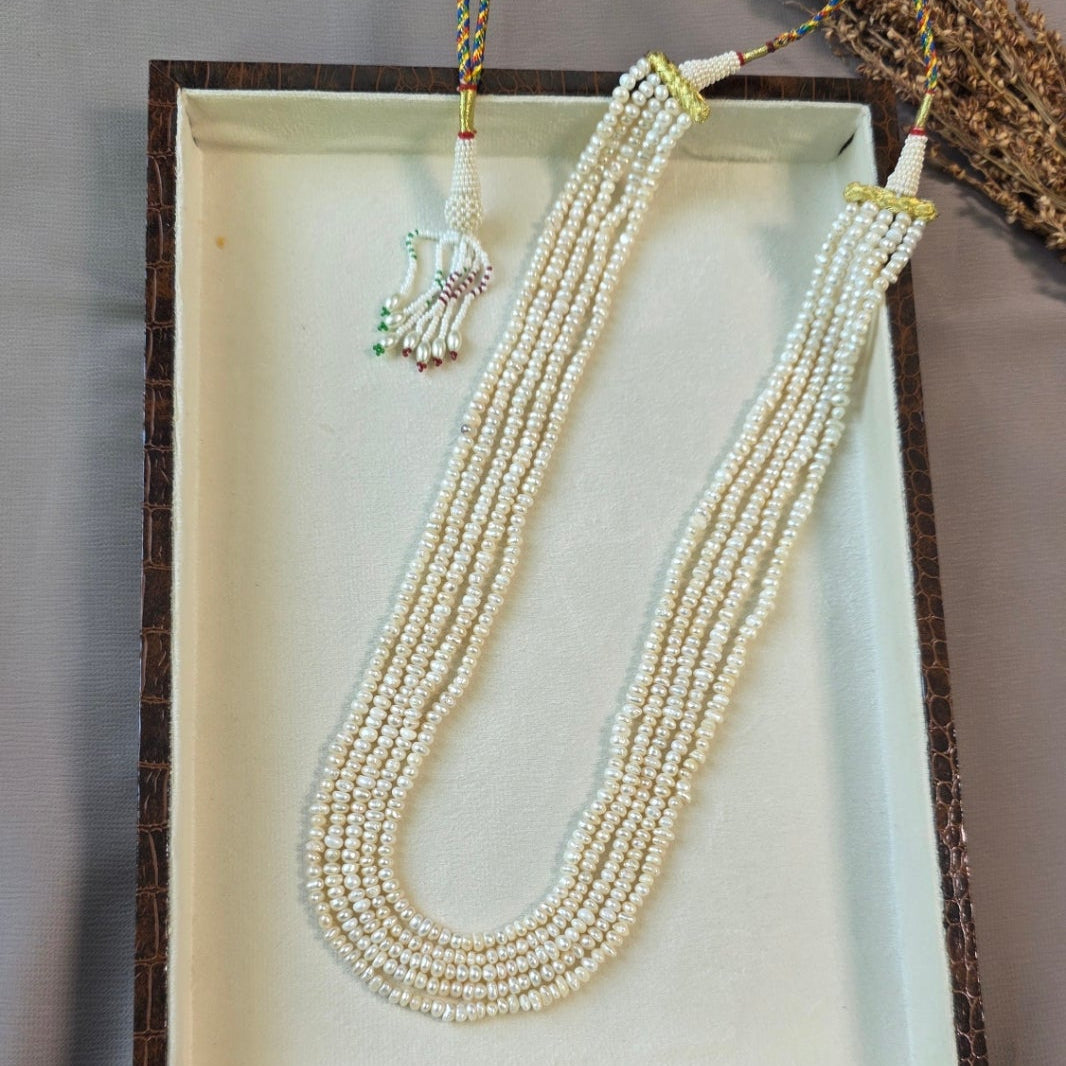 Handcrafted multi-strand freshwater pearl mala necklace with adjustable dori displayed in a jewelry box