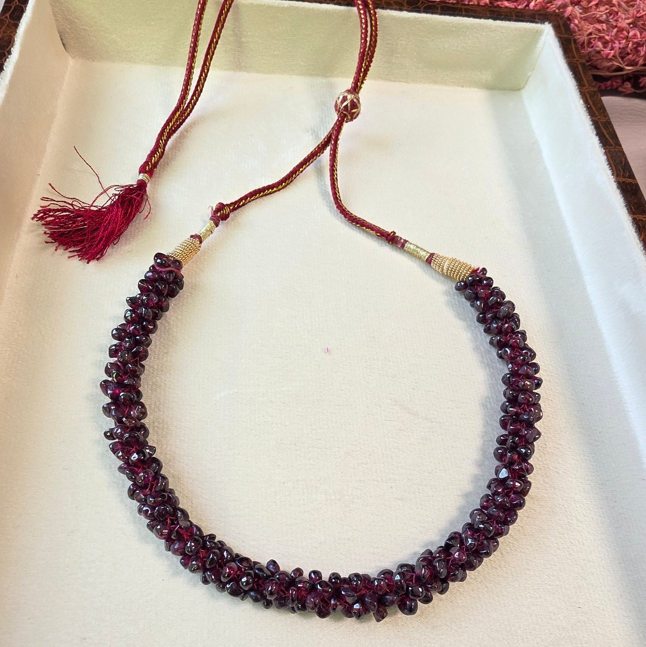 Handcrafted natural garnet stone mala necklace with deep red polished beads and adjustable thread closure.