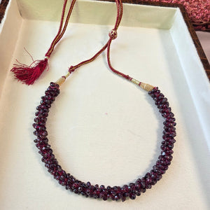 Handcrafted natural garnet stone mala necklace with deep red polished beads and adjustable thread closure.