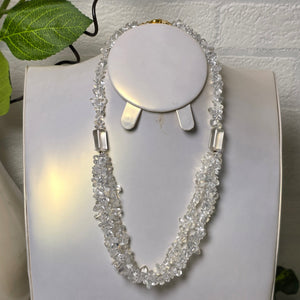 Close-up of a decorative headband with crystals on a white surface.