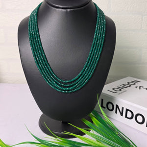 Black and green earbud with a white container labeled 'LONDON' on a light background
