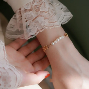 Elegant 18K gold-plated leaf bracelet with genuine freshwater pearls displayed on hand – minimalist nature-inspired jewelry for women