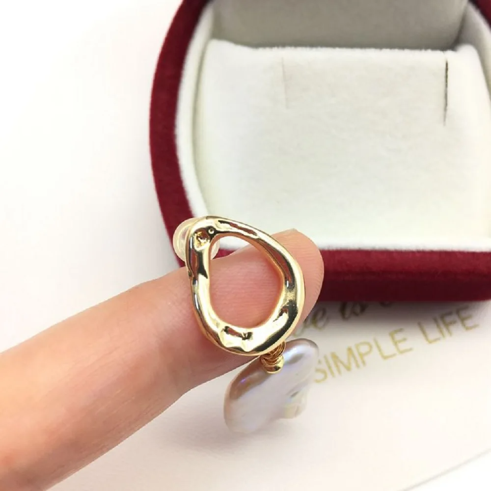 Baroque freshwater pearl drop earrings with gold abstract stud design in a velvet gift box.