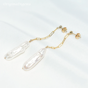 Gold chain earrings with clear teardrop-shaped pendants on a white background