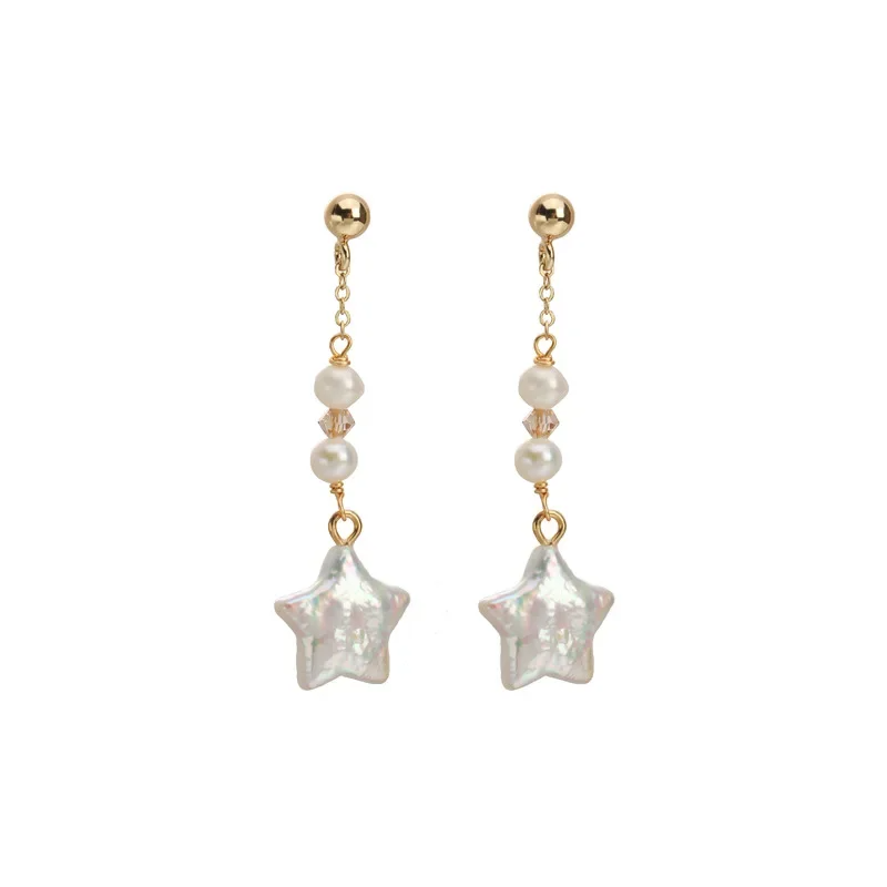 Gold-plated star-shaped freshwater pearl drop earrings by Urban Gear UG on brown fabric background

