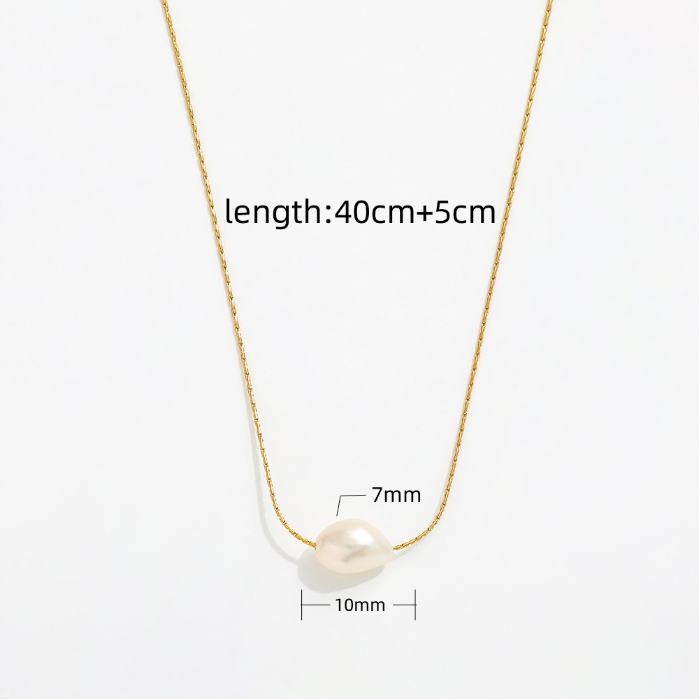 Close-up of dainty freshwater pearl pendant necklace on gold chain