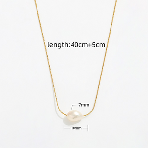 Close-up of dainty freshwater pearl pendant necklace on gold chain