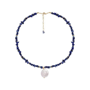 Woman wearing elegant baroque freshwater pearl pendant necklace with blue lapis lazuli chip beads