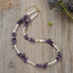 "Handmade necklace with freshwater pearls and gemstones including black obsidian, turquoise, amethyst, and lapis lazuli"