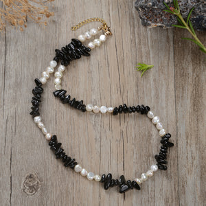 "Handmade necklace with freshwater pearls and gemstones including black obsidian, turquoise, amethyst, and lapis lazuli"