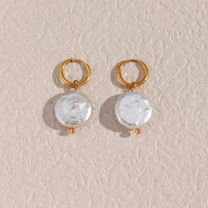 Minimalist freshwater pearl hoop earrings featuring a sleek gold-plated design