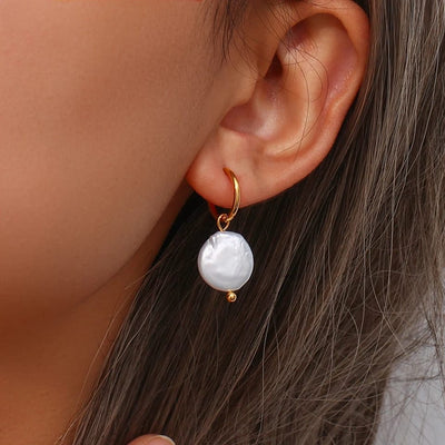 Minimalist freshwater pearl hoop earrings featuring a sleek gold-plated design