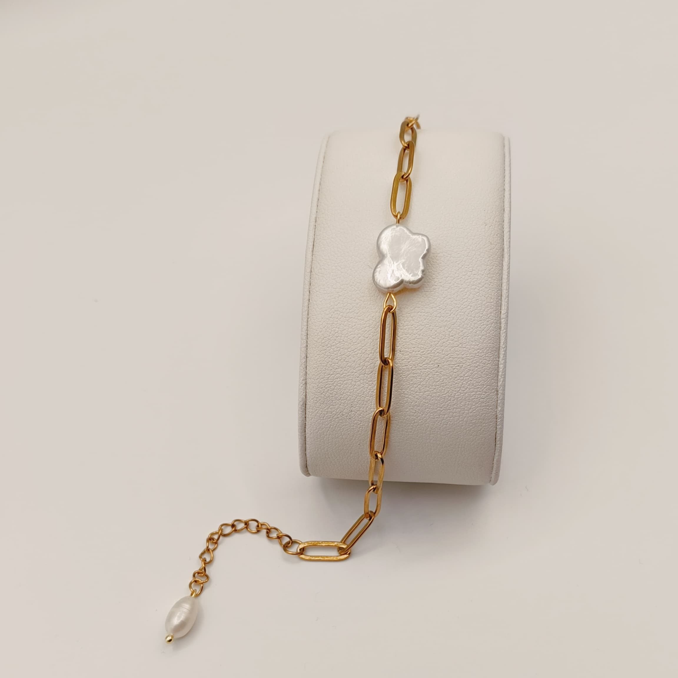 18K gold-plated chain bracelet with a natural freshwater pearl butterfly charm, displayed on a white jewelry stand.