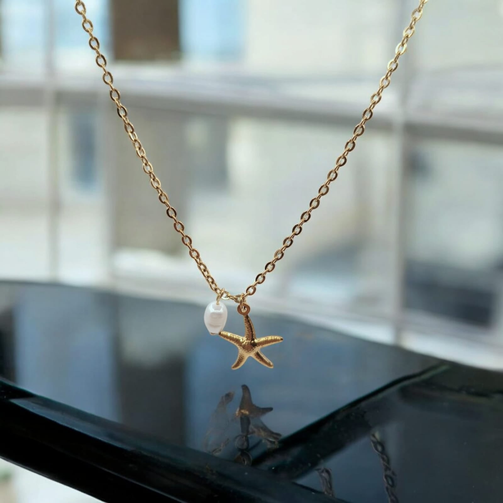 18K Gold-Plated Starfish Pendant Necklace with Freshwater Pearl on a white background