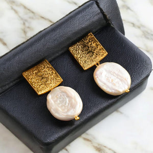 Square Earrings with Baroque Freshwater Pearls displayed on a black jewelry box."

