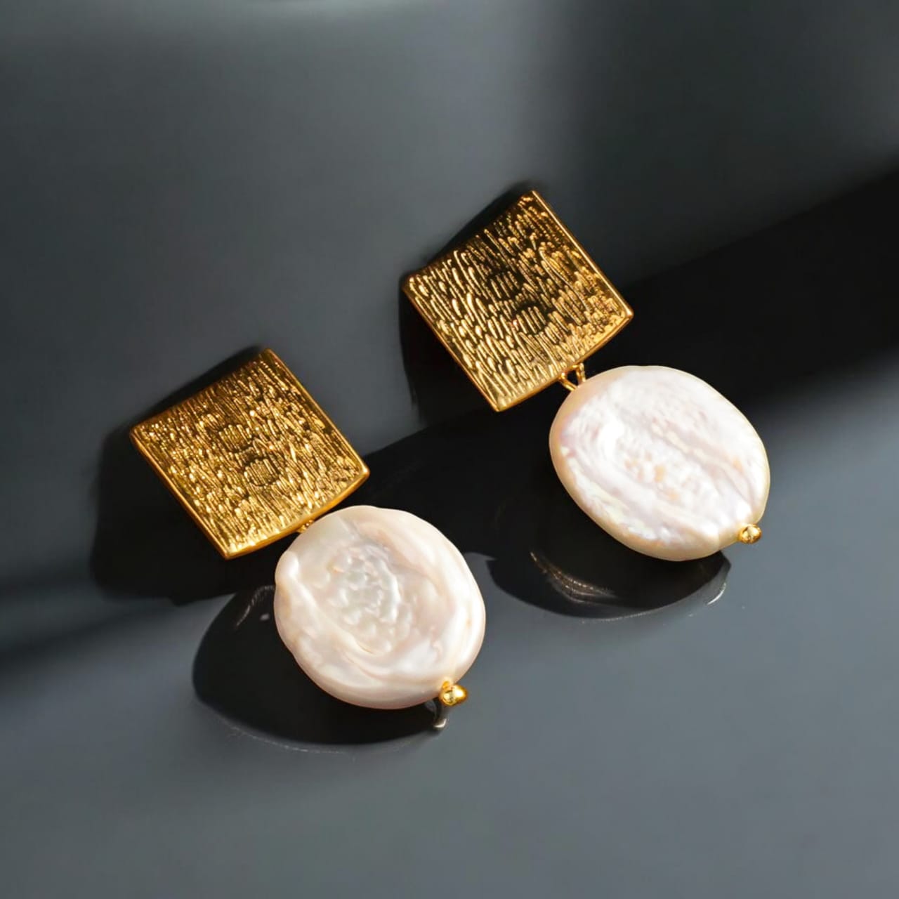 Square Earrings with Baroque Freshwater Pearls displayed on a black jewelry box."

