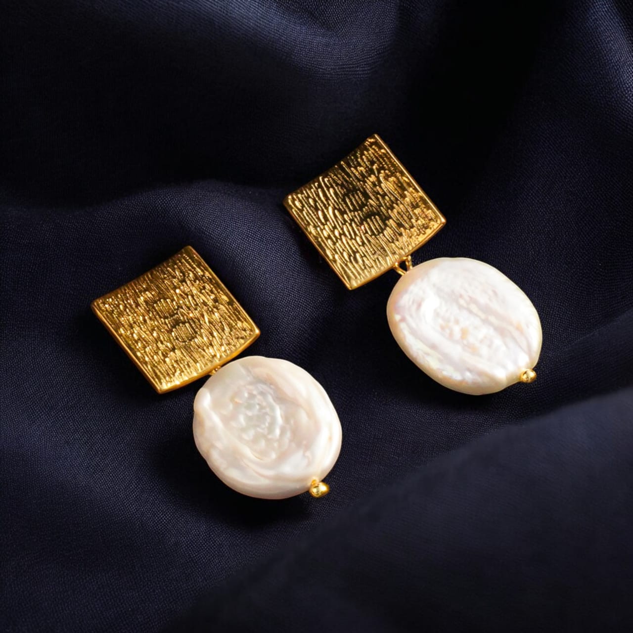 Square Earrings with Baroque Freshwater Pearls displayed on a black jewelry box."

