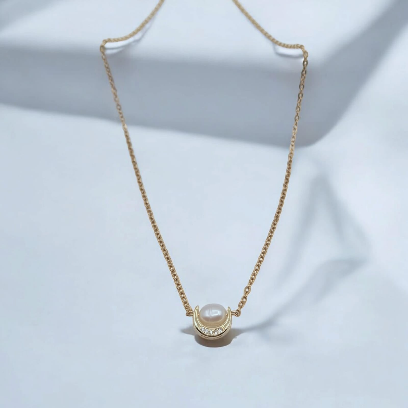 18K Gold-Plated Crescent Moon Necklace with Freshwater Pearl displayed on a minimalist background.