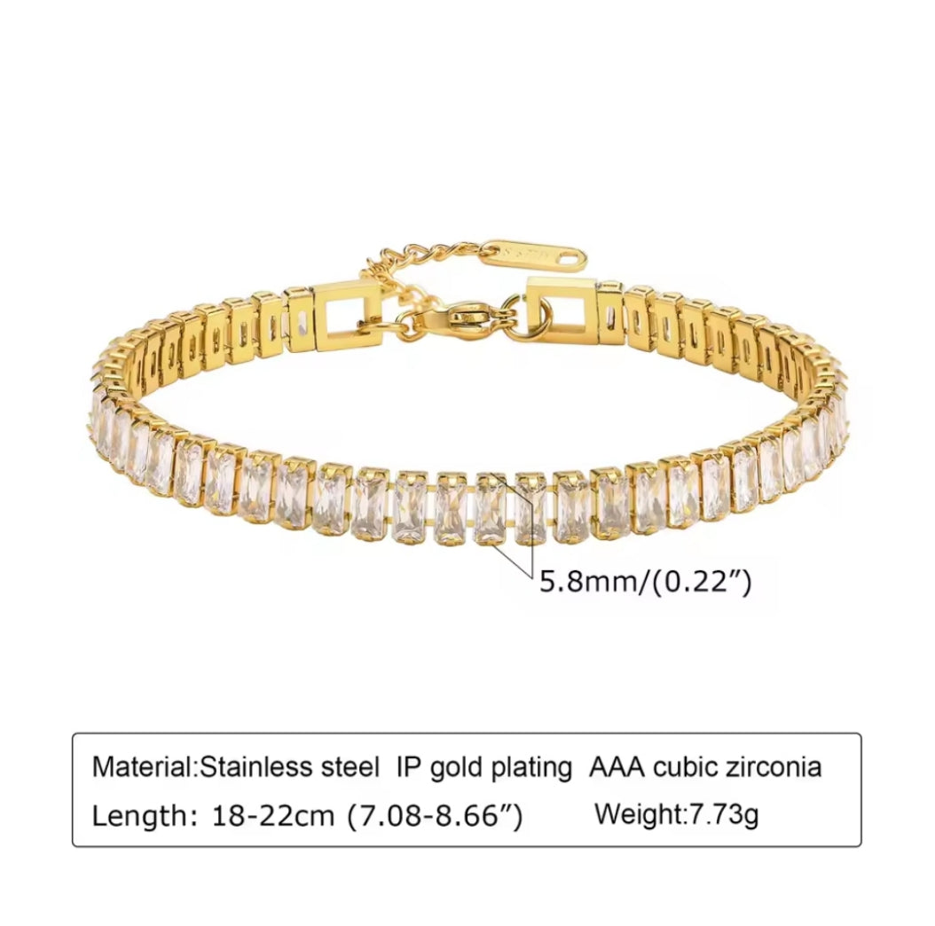 Gold bracelet with clear stones on a white background