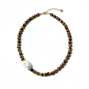 Beaded necklace with a white pendant on a white background