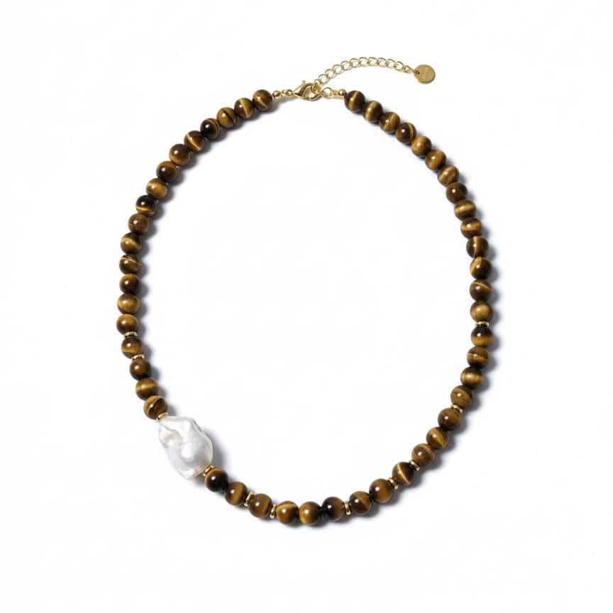 Beaded necklace with a white pendant on a white background