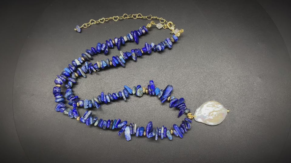 Woman wearing elegant baroque freshwater pearl pendant necklace with blue lapis lazuli chip beads