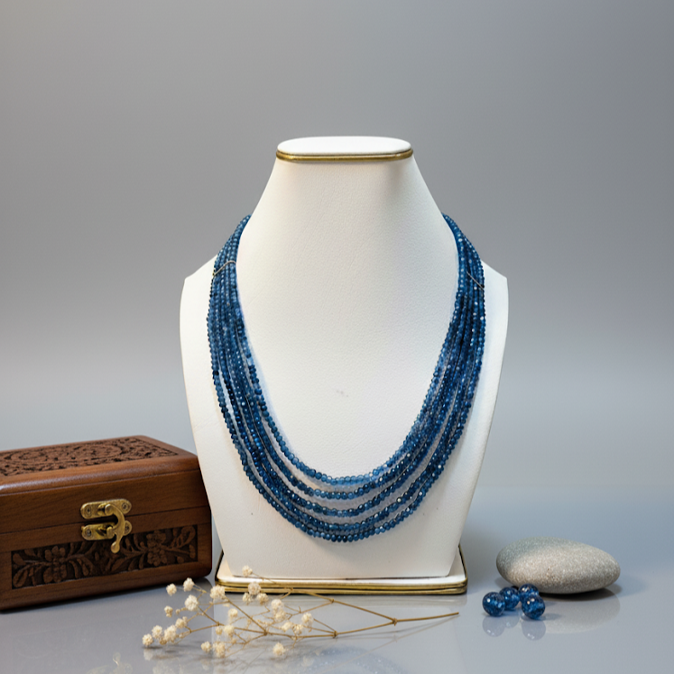 Blue jade multi-layer mala necklace displayed on jewelry stand.